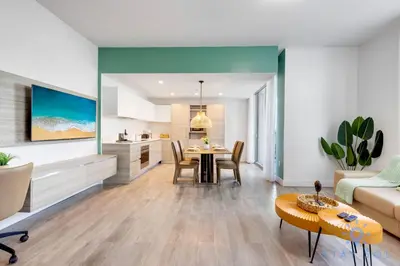 a kitchen and living room with a table and a couch at Rooftop Pool - Hollywood Beach Boardwalk in Hollywood
