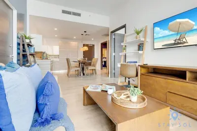 a living room with a couch and a table at EXCLUSIVE APARTMENT - Rooftop POOL- Beachfront in Hollywood
