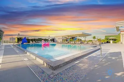 a pool at a resort with a person in the water at EXCLUSIVE APARTMENT - Rooftop POOL- Beachfront in Hollywood