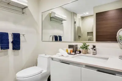 a white bathroom with a toilet and a sink at Ocean View - Balcony - Hollywood Beach Broad-walk in Hollywood