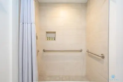 a bathroom with a shower with a shower curtain at NEW!Beachfront Condo Resort- Balcony in Hollywood
