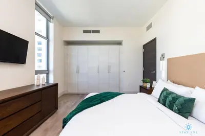 a bedroom with a large white bed and a flat screen tv at Best Stay - Rooftop Pool - Hollywood Beach Board - walk in Hollywood