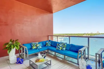 a blue couch on a balcony with a view of the water at Best Stay - Rooftop Pool - Hollywood Beach Board - walk in Hollywood