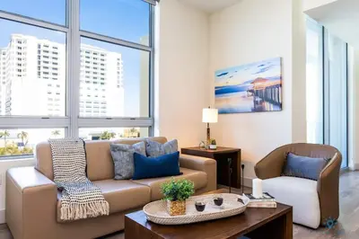 a living room with a couch and a table at Best Stay - Rooftop Pool - Hollywood Beach Board - walk in Hollywood