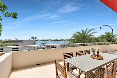 a patio with a table and chairs on a balcony at Beachfront Condo-ROOFTO POOL- 2 BEDROOMS 2 BR ! in Hollywood
