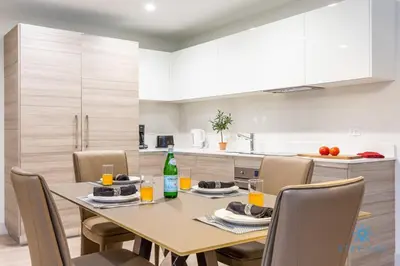 a dining room table and chairs in a kitchen at NEW LUXURY Beachfront Condo Resort in Hollywood