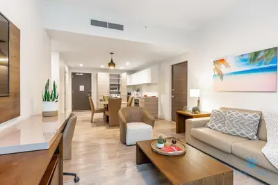 a living room with a couch and a table at NEW LUXURY Beachfront Condo Resort in Hollywood