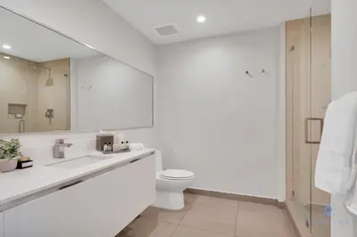 a bathroom with a sink and a toilet and a mirror at Best Stay - Rooftop Pool & Hot Tub - Hollywood Beach in Hollywood
