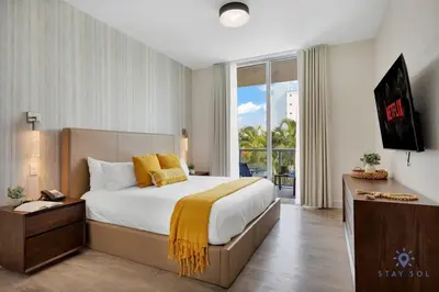 a bedroom with a large bed and a large window at Best Stay - Rooftop Pool & Hot Tub - Hollywood Beach in Hollywood