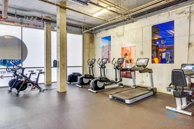 a gym with several treadmills and exercise bikes at Rooftop Pool - Balcony - Hollywood Beach Broad - walk in Hollywood