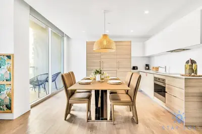 a kitchen and dining room with a wooden table and chairs at Costa Hollywood - Worth Traveling - Rooftop Pool- Gym in Hollywood