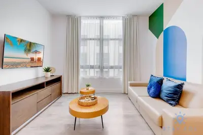 a living room with a couch and a table at Lx Oasis Beachfront-Rt infinity POOL in Hollywood