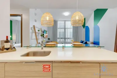 a kitchen with a sink and two pendant lights at Lx Oasis Beachfront-Rt infinity POOL in Hollywood