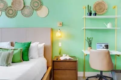 a bedroom with green walls and a bed with a desk at Amazing Pool - Balcony - Hollywood Beach Broad - walk in Hollywood