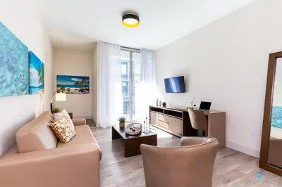 a living room with a couch and a table at Best Stay - Rooftop Pool - Broad - walk - Near Beach in Hollywood