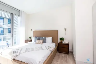 a bedroom with a large bed and a large window at Best Stay - Rooftop Pool - Broad - walk - Near Beach in Hollywood