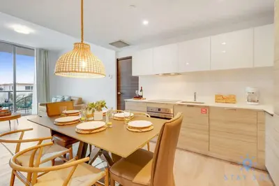 a kitchen with a table with chairs and a dining room at Rooftop Pool & Hot Tub - Gym - Hollywood Beach in Hollywood