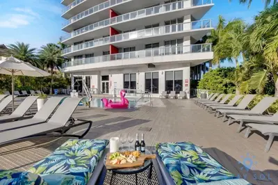 a resort with lounge chairs and a building at Amenities BALCONY w Stunning Views-Beachfront in Hallandale Beach