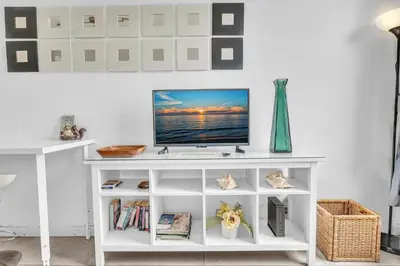 a white entertainment center with a television on it at Lovely apartment in the heart of South Beach in Miami Beach