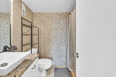 a bathroom with a white toilet and a sink at Lovely apartment in the heart of South Beach in Miami Beach