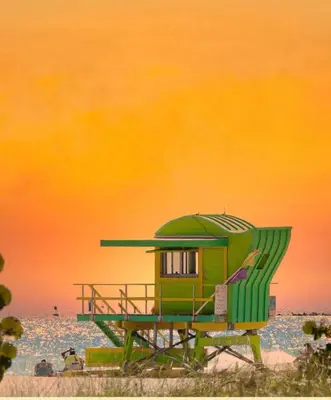 a green lifeguard shack on a beach with the ocean at Lovely apartment in the heart of South Beach in Miami Beach