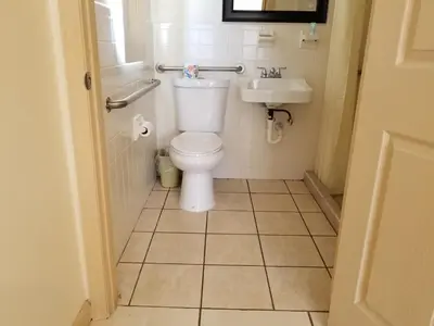 a bathroom with a toilet and a sink at Parkway Inn in Miami