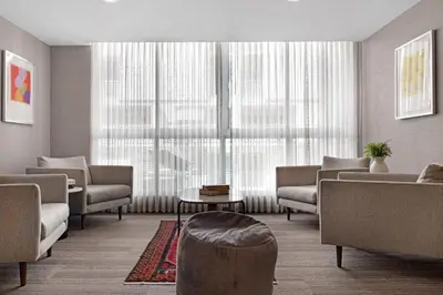 a living room with furniture and a large window at Roami at Habitat Brickell in Miami