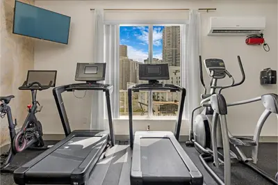 a gym with three exercise bikes and a window at Roami at Habitat Brickell in Miami