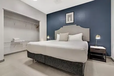 a bedroom with a large bed with a blue wall at Roami at Habitat Brickell in Miami