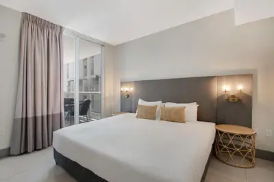 a bedroom with a large bed and a large window at Roami at Habitat Brickell in Miami
