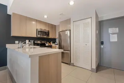 a kitchen with a counter top and a refrigerator at Roami at Habitat Brickell in Miami