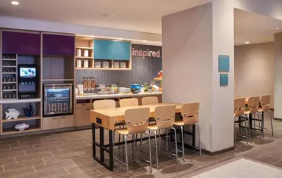 a restaurant with a table and chairs and a counter at Home2 Suites By Hilton Ft. Lauderdale Downtown, Fl in Fort Lauderdale