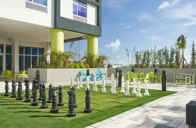 a giant chessboard on a lawn in front of a building at Tru By Hilton Fort Lauderdale Downtown-Flagler Village in Fort Lauderdale