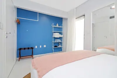 a bedroom with a blue accent wall and a bed at Roami at 250 Collins in Miami Beach