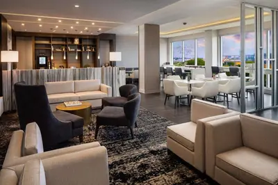 a hotel lobby with couches and a bar at Hilton Miami Aventura in Aventura