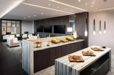 a lobby with a counter with food on it at Hilton Miami Aventura in Aventura