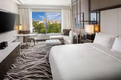 a hotel room with a large bed and a large window at Hilton Miami Aventura in Aventura