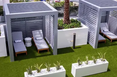a rendering of a patio with chairs and plants at Hilton Miami Aventura in Aventura