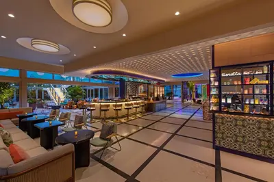 a lobby of a hotel with a bar at Moxy Miami South Beach in Miami Beach