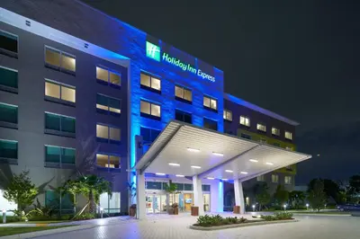 a hospital building with a blue lit up building at Holiday Inn Express Doral Miami by IHG in Doral