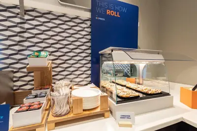 a display case with donuts and other pastries at Holiday Inn Express Doral Miami by IHG in Doral