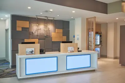 a lobby with a counter with boxes on it at Holiday Inn Express Doral Miami by IHG in Doral