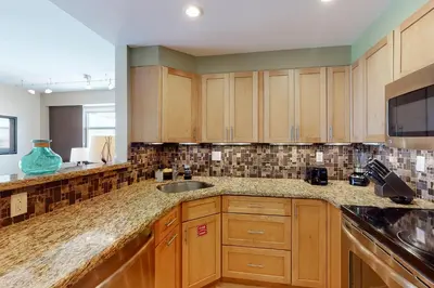 a kitchen with wooden cabinets and a sink at Paradise Perch in Fort Lauderdale