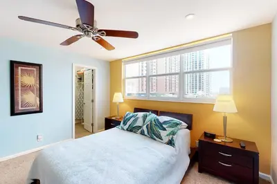a bedroom with a bed and a ceiling fan at Paradise Perch in Fort Lauderdale