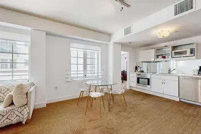 a kitchen and living room with a table and chairs at The Carlyle 3G in Miami Beach