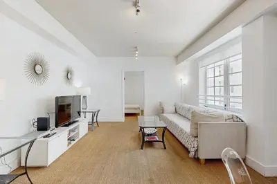 a living room with a couch and a tv at The Carlyle 3G in Miami Beach