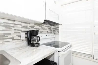 a kitchen with a coffee maker on a counter at Apartments on Ocean Drive in Miami Beach