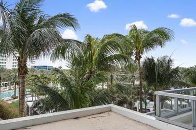 a view from the balcony of a resort with palm trees at Junior Suite at Sorrento Residences- FontaineBleau Miami Beach home in Miami Beach