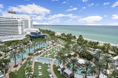 an aerial view of a resort with palm trees and the beach at Junior Suite at Sorrento Residences- FontaineBleau Miami Beach home in Miami Beach