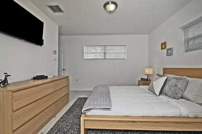 a bedroom with a bed and a flat screen tv at Relax and enjoy Fort Lauderdale beach! in Fort Lauderdale